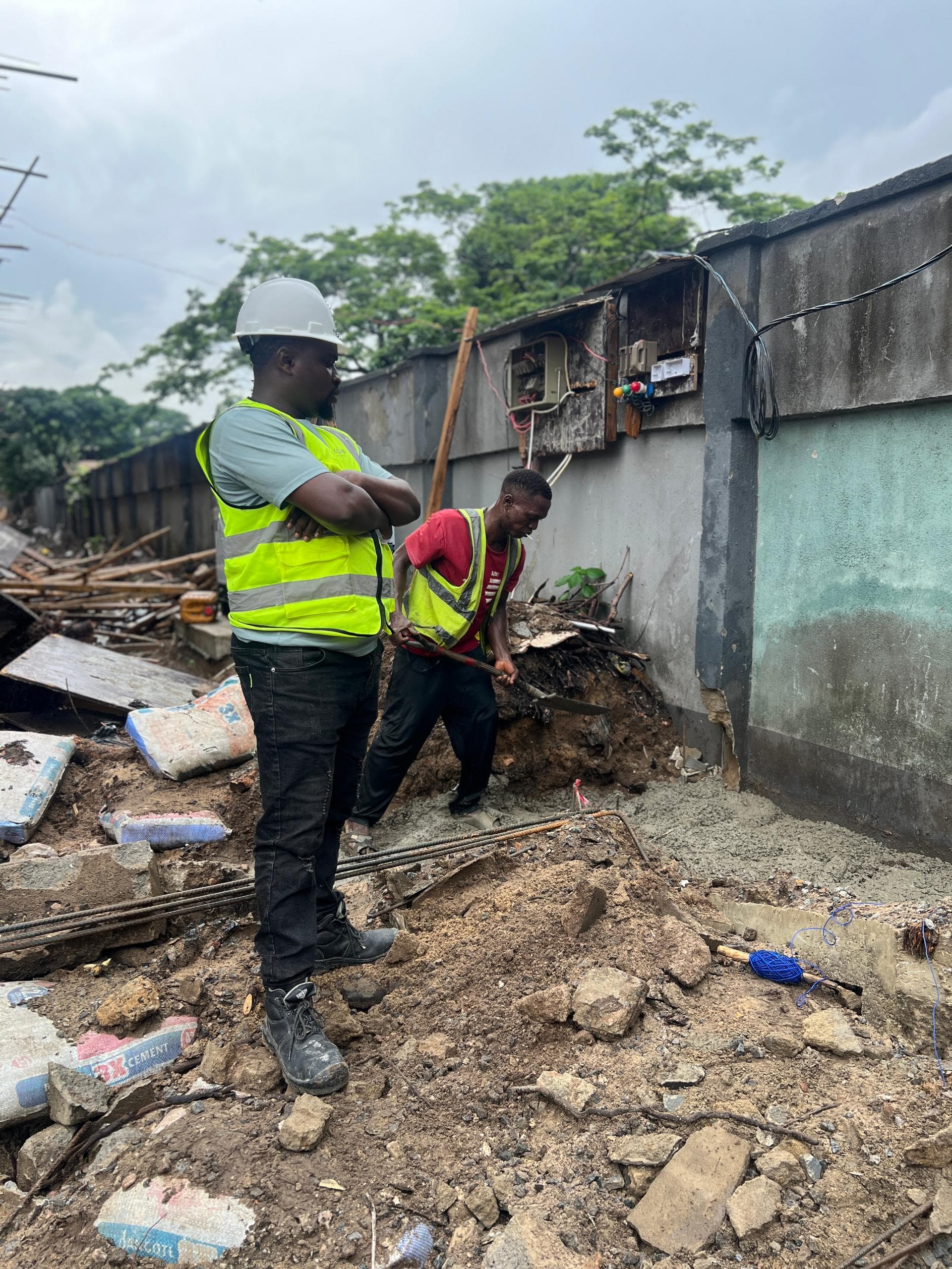 Site worker supervising foundation trenching