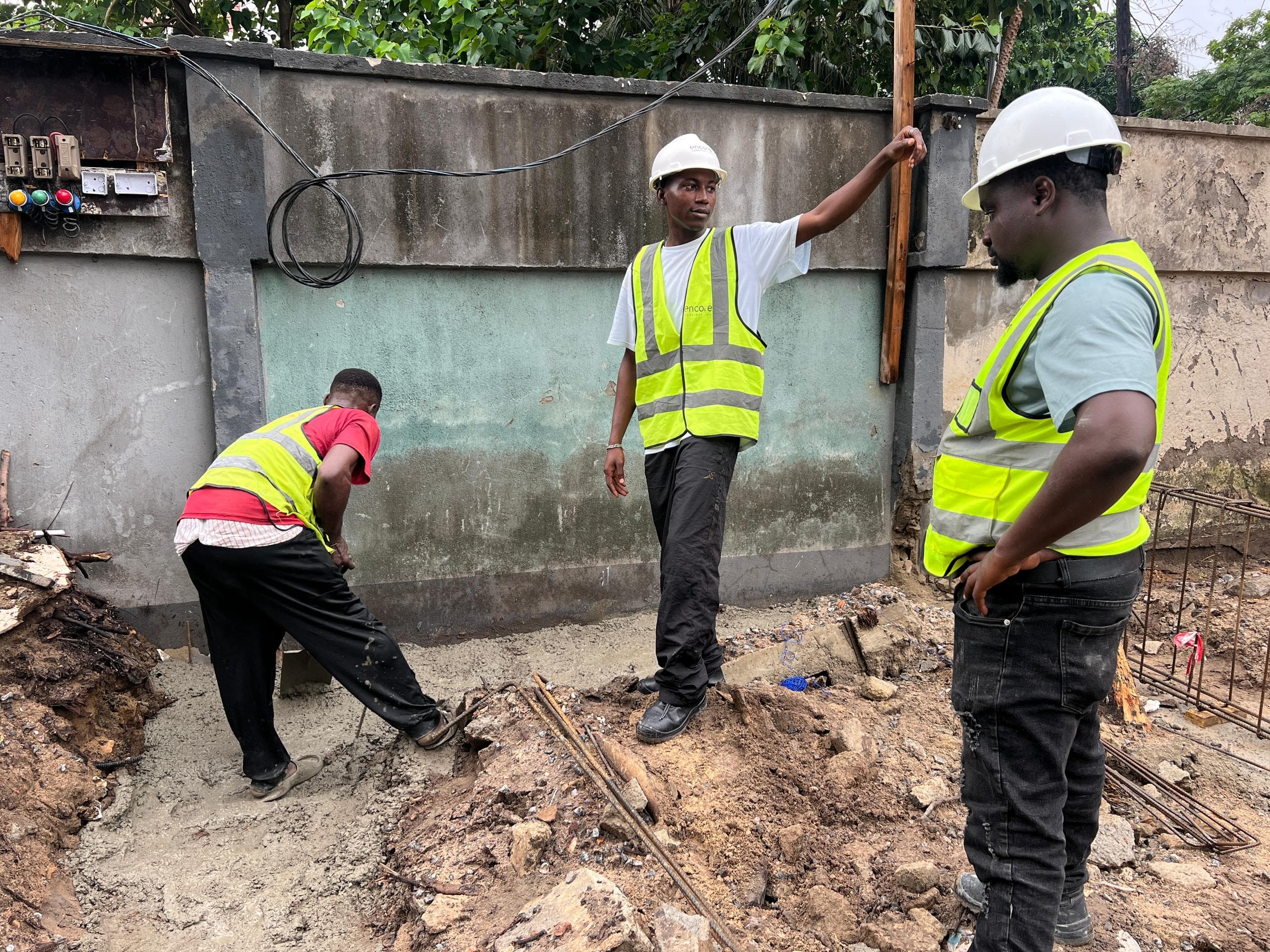 Construction team collaborating around foundation works